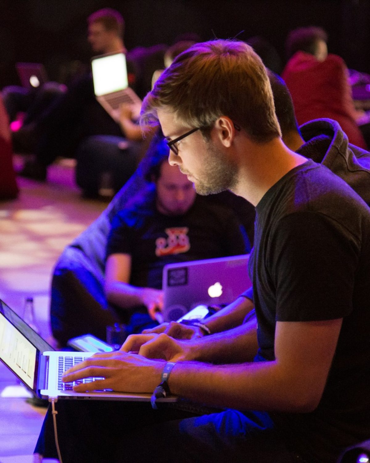 man using laptop in front of brown chair